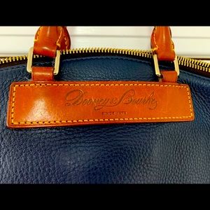 This classic blue Dooney & Burke leather bag is timeless! It has been well loved